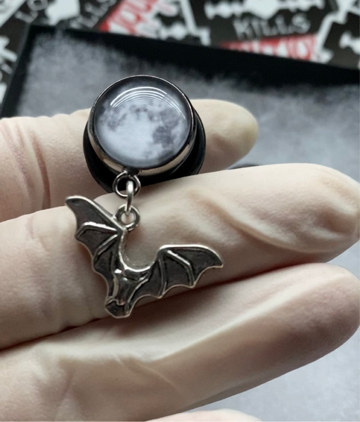 Full moon and bat dangle plugs, gauges for stretched lobes. 